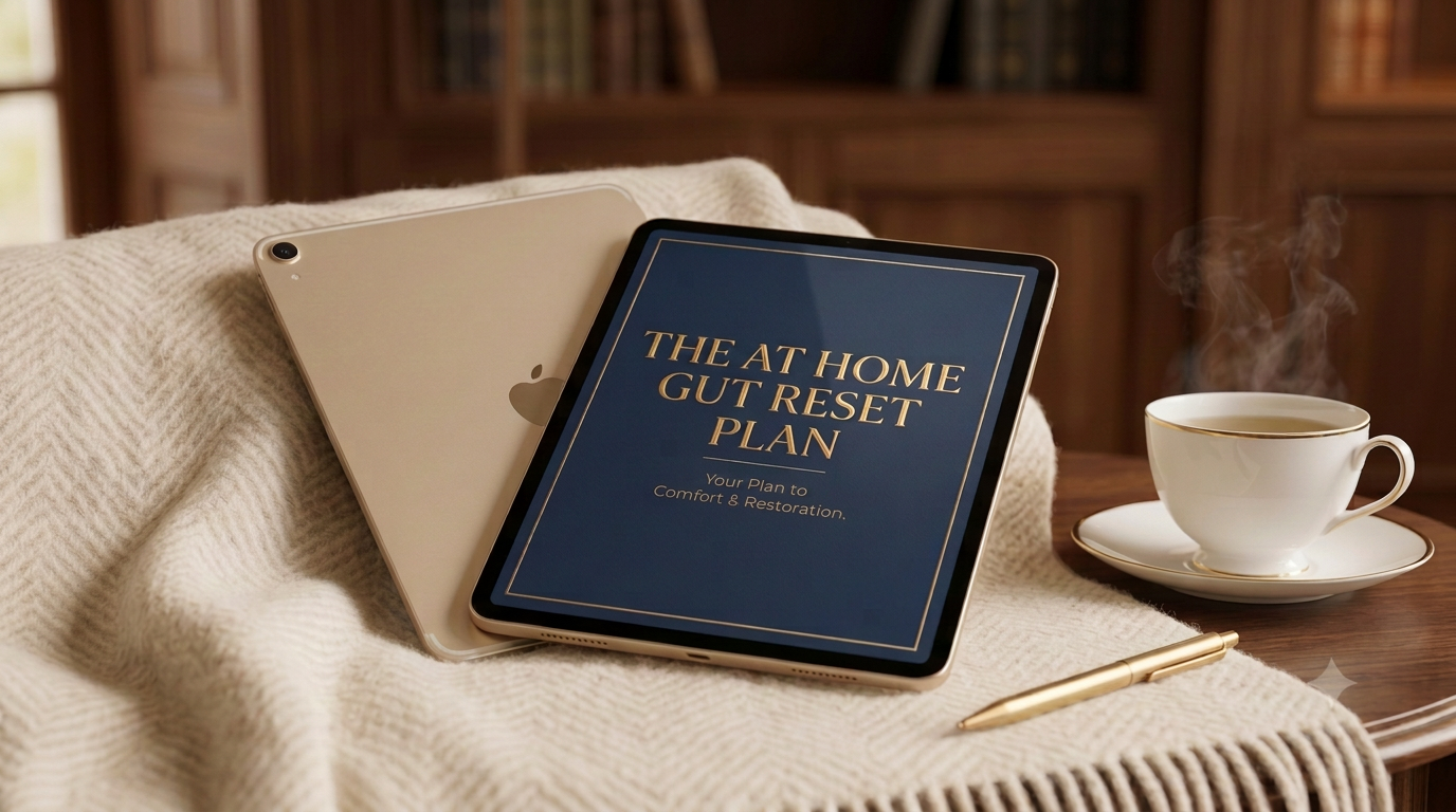 The At Home Gut Reset Plan — displayed on an iPad beside a gold-rimmed teacup